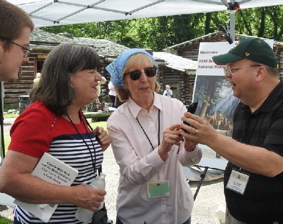 Author Sue Kelly Ballard (center) shares informaiton with visitors.